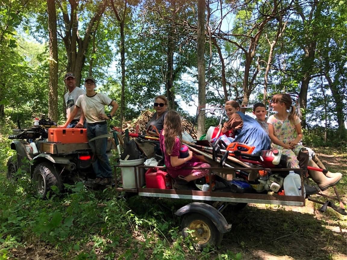 Volunteers riding on a trailer during a workday